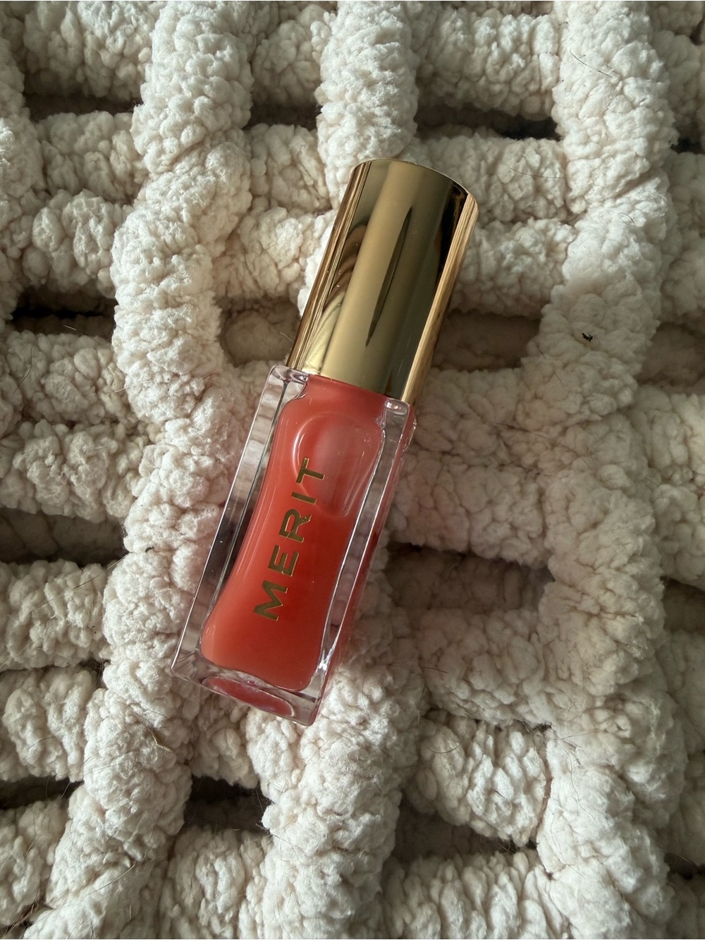 Merit tinted lip oil in Jete